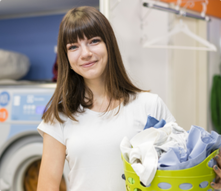 clean and soft water for laundry - women smiling with clothes in hand